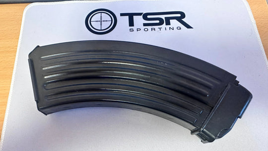 Black curved rifle magazine on TSR Sporting mat, for competition shooting and hunting