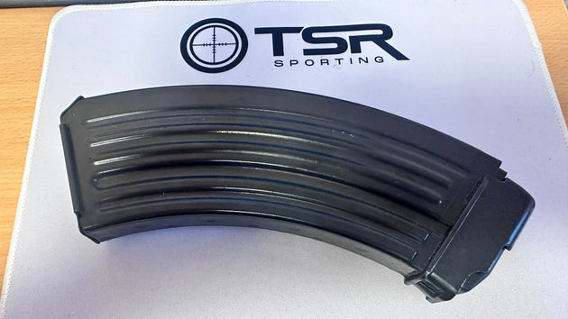 Black curved rifle magazine on TSR Sporting mat, for competition shooting and hunting