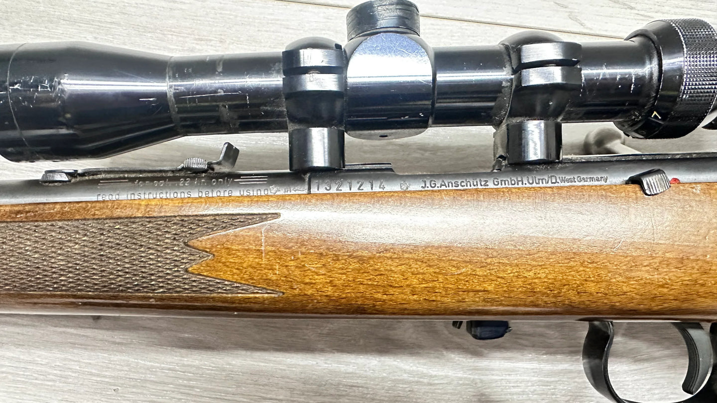 J.G. Anschütz .22 LR rifle with scope, wooden stock, and engraved details for target shooting or collecting