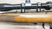 J.G. Anschütz .22 LR rifle with scope, wooden stock, and engraved details for target shooting or collecting