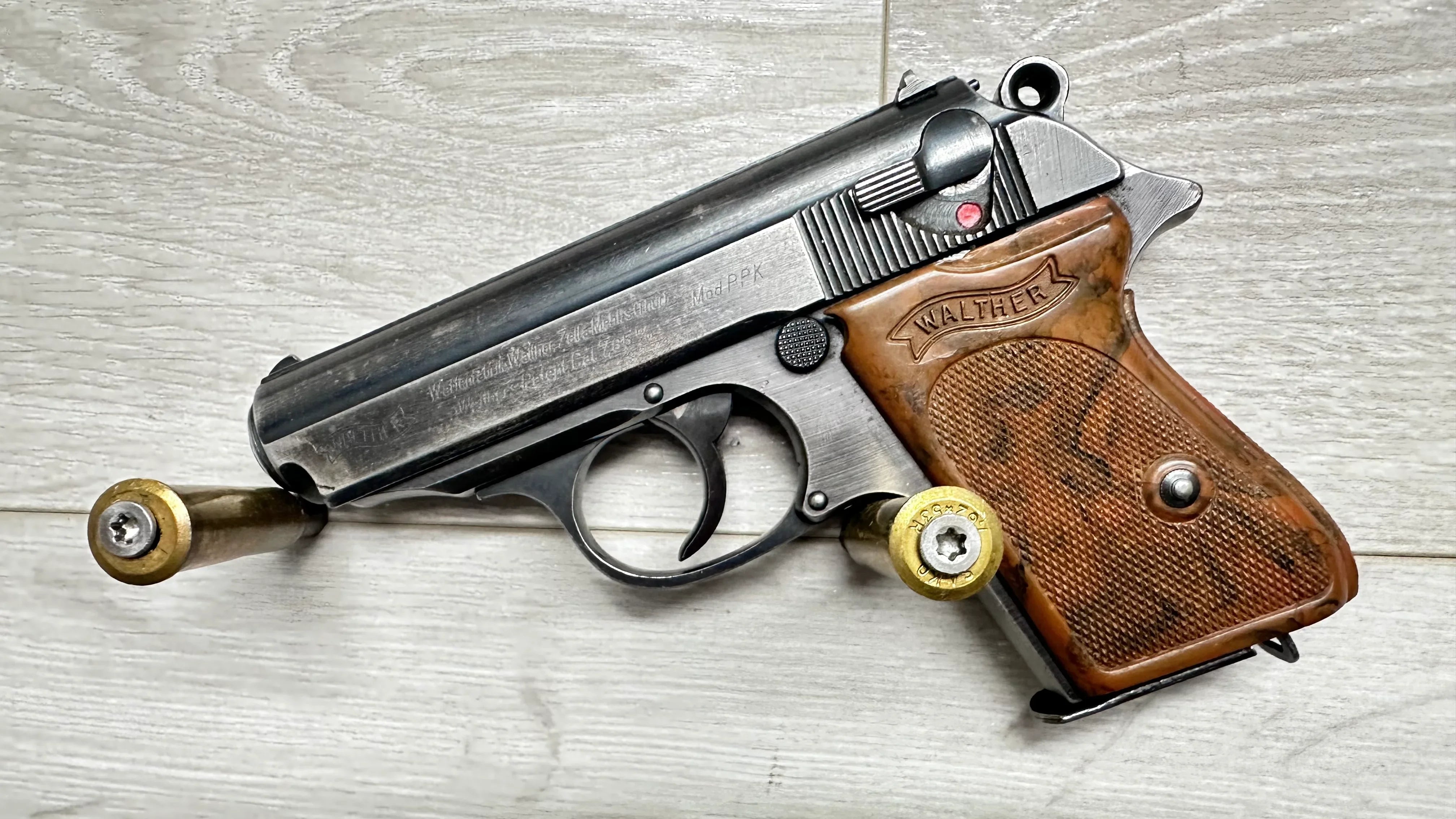Walther PPK pistol with wooden grips and 7.65mm ammo, vintage firearm for collection or sport shooting
