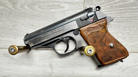 Walther PPK pistol with wooden grips and 7.65mm ammo, vintage firearm for collection or sport shooting