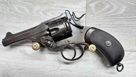 Webley Mark IV revolver with .455 caliber, vintage military firearm, collectible handgun on wood surface