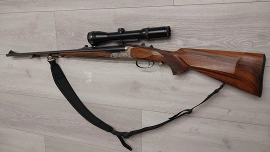 Hunting rifle with scope and wooden stock, ideal for sport shooting and collection