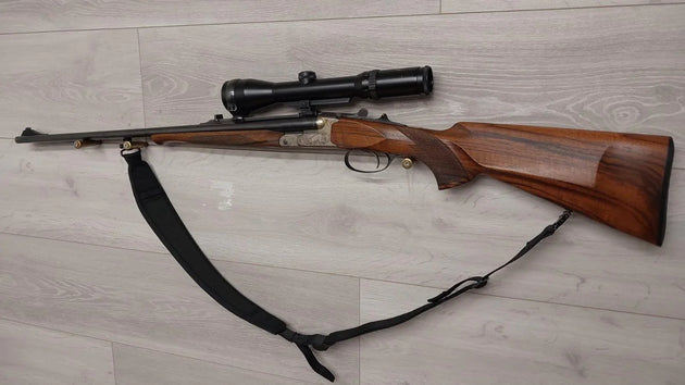 Hunting rifle with scope and wooden stock, ideal for sport shooting and collection