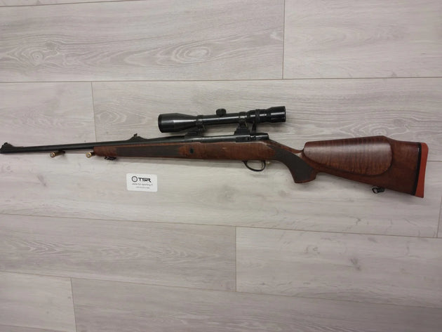 Bolt-action rifle with scope, wooden stock, for hunting or sport shooting