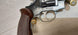 German-made revolver with wooden grip and brass cartridges, ideal for collectors and shooting sports.