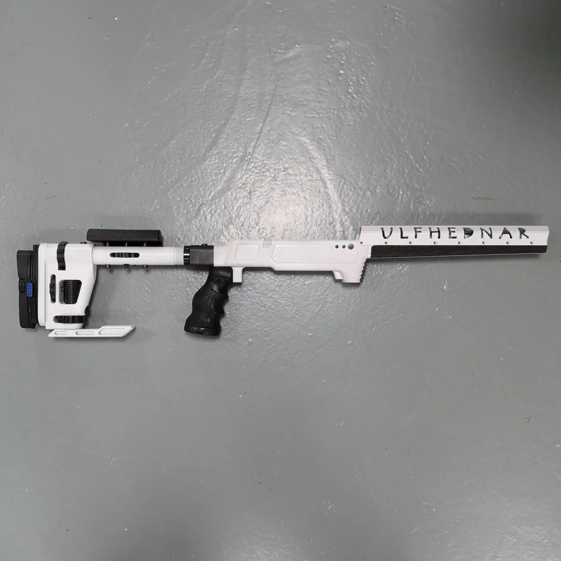 White Ulfhednar precision rifle with black grip, ideal for competitive shooting and hunting.
