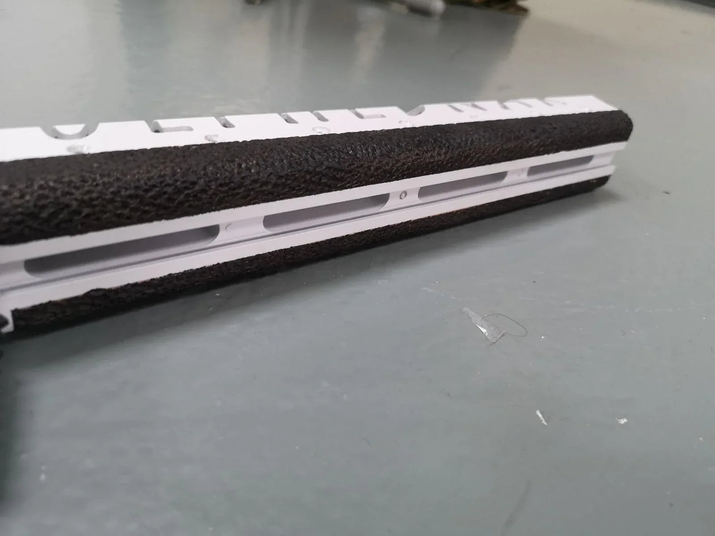 White and black textured rifle stock for competition shooting, hunting, or military use