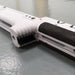 White tactical rifle stock with black textured grip, designed for precision shooting and competition use.