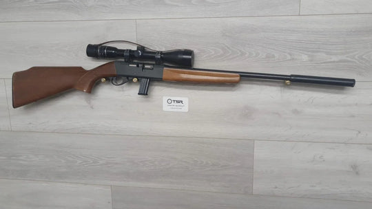 Bolt-action rifle with scope, wooden stock, and suppressor for hunting or sport shooting