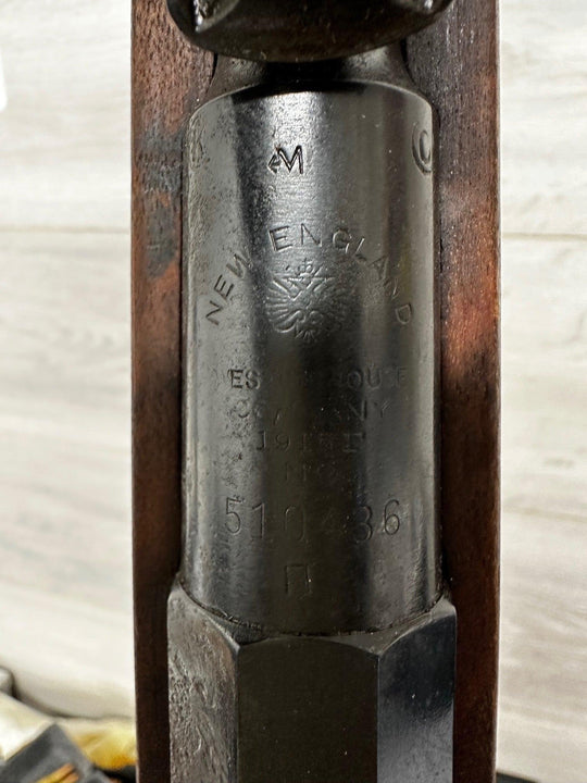 Vintage New England rifle receiver with engraved markings and wooden stock, collectible militaria