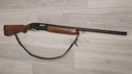 Used hunting shotgun with wooden stock and sling, ideal for sport shooting and collection