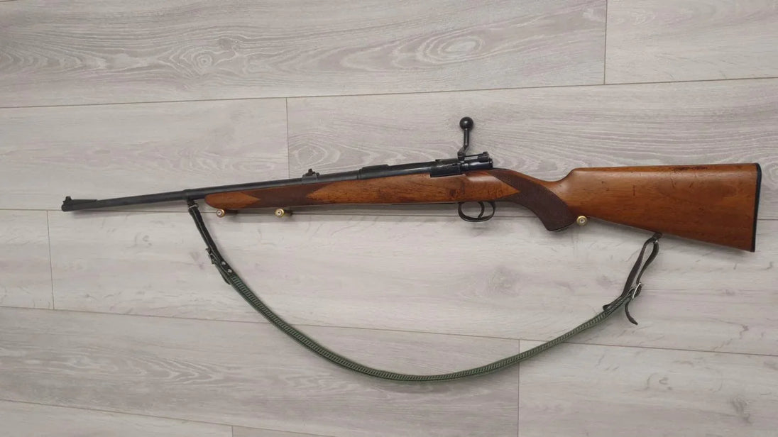 Wooden stock rifle with sling, ideal for hunting or sport shooting