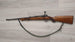 Wooden stock rifle with sling, ideal for hunting or sport shooting