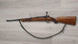 Wooden stock rifle with sling, ideal for hunting or sport shooting