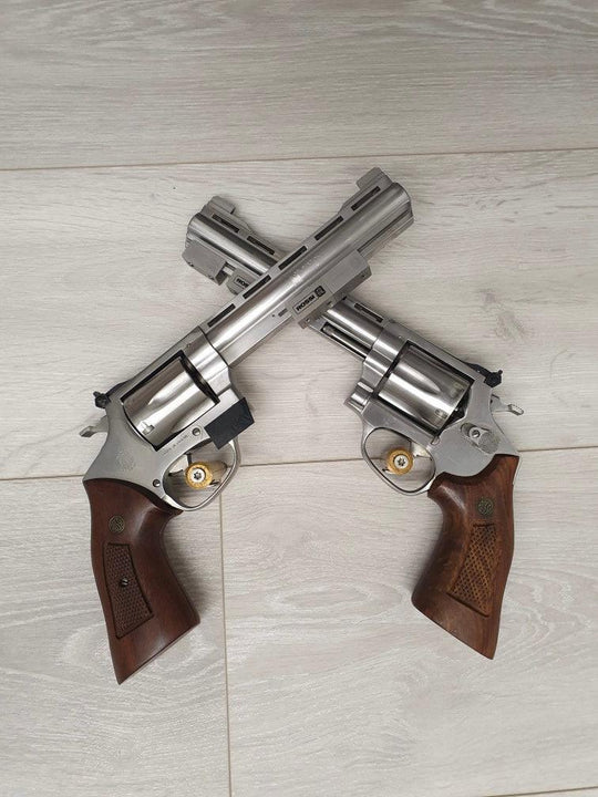 Two stainless steel revolvers with wooden grips, ideal for sport shooting and hunting.