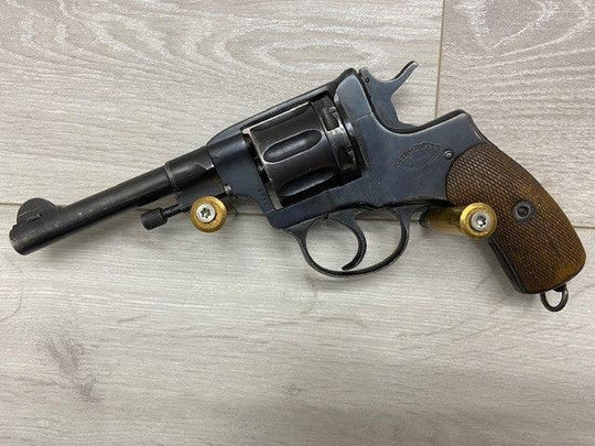 Vintage revolver with wooden grip and brass accents, ideal for collectors and shooting sports